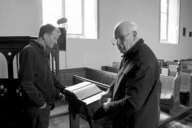 Chris Rockett and Michael Duffield looking at the Button account book